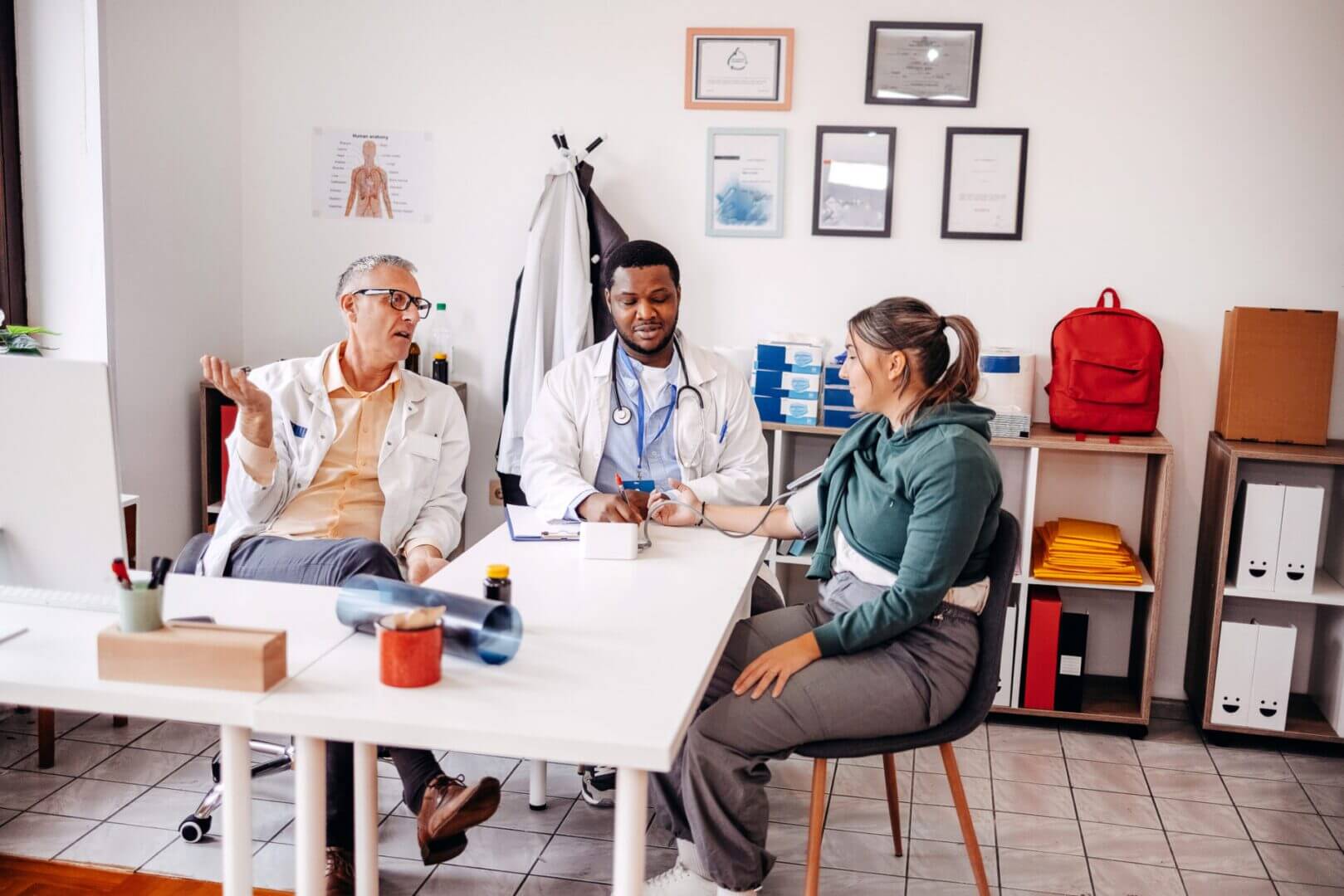 Doctors consulting with a patient in office.