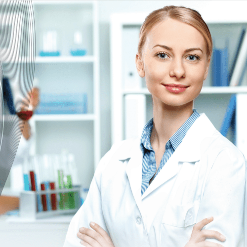 Smiling scientist in a laboratory setting.